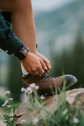 A hiker ties up his shoes